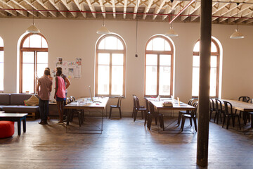 Creative business people talking in circle in office