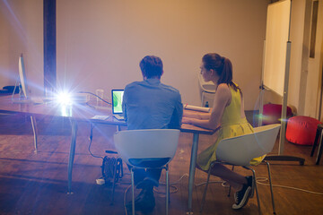 Lens flare over creative business people working in office