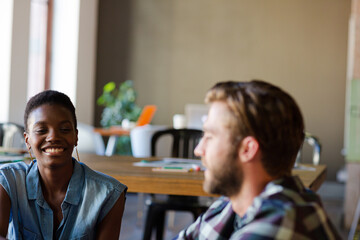 Smiling casual business people talking in office
