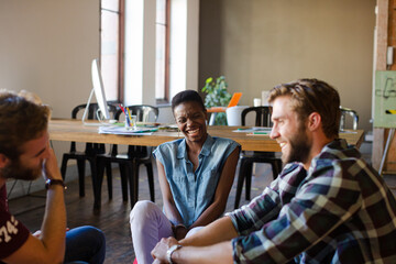 Casual business people meeting in circle in sunny office