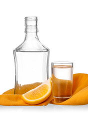 Bottle and shot of tasty tequila with lemon on white background