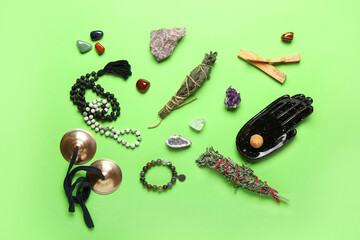 Composition with gemstones, karatalas and herbs for aura cleansing on color background
