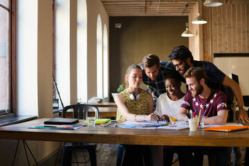 Creative business people brainstorming and working in office