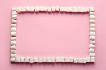 Frame made of tasty marshmallows on color background