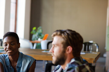 Smiling casual business people talking in office