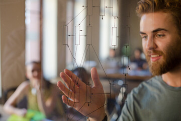 Casual businessman explaining diagram on glass in meeting