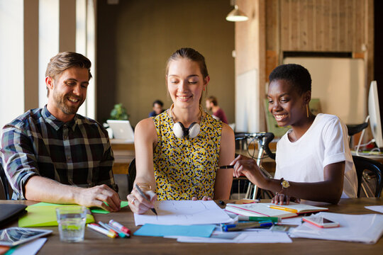 Casual business people discussing paperwork in office