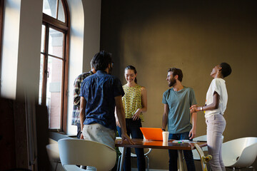 Casual business people meeting in circle in sunny office