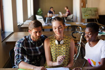 Casual business people discussing paperwork in office