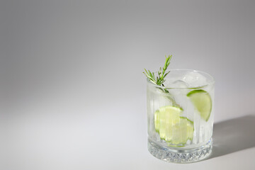 Glass of cold gin and tonic on white background