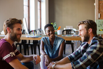 Casual business people meeting in circle in sunny office