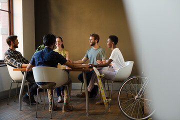 Casual business people meeting in circle in sunny office