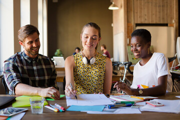 Casual business people discussing paperwork in office