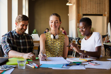 Casual business people discussing paperwork in office