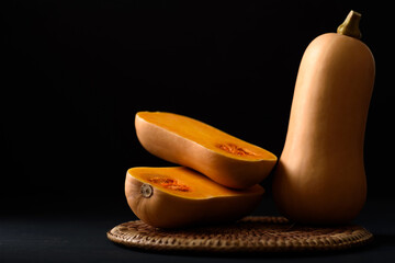 Butternut squash on black background, vegetable ingredient for healthy food in autumn and fall...
