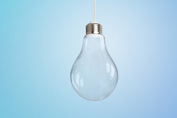 Light bulb on light blue background