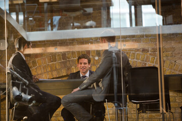 Businessmen talking indoors