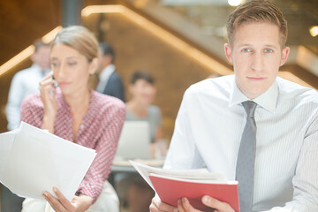 Business people reviewing paperwork in office