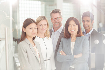 Portrait of confident business people in sunny office