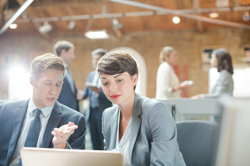 Business people working at laptop