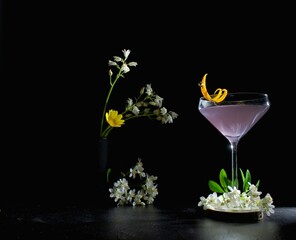 Violet, purple cocktail alcoholic drink beverage against a black background