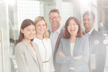 Fototapeta premium Portrait of confident business people in sunny office