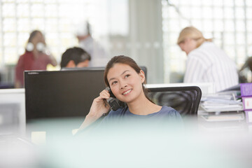 Smiling businesswoman talking on cell phone