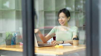 Young business employee meeting with business client at coffee shop