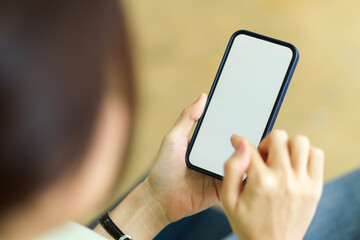 Smartphone blank screen mockup using by female with blurred background