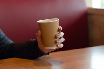 person drinking coffee in cafe