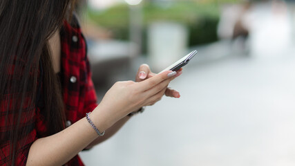 Cropped image of Charming asian woman using mobile phone