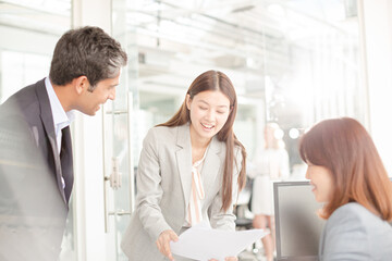 Business people reviewing paperwork at desk in office