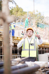 Engineer with blueprints walkie-talkie working at construction site