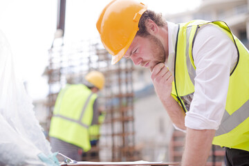 Foreman reading clipboard at construction site