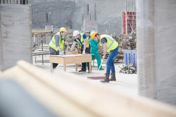 Construction worker sweeping at construction site