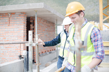 Constructor workers assembling rebar structure at construction site