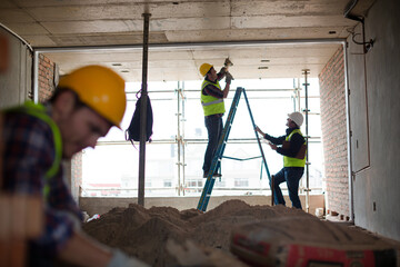 Construction worker on ladder at construction site © KOTO