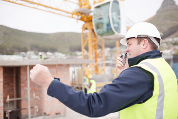 Construction worker with walkie-talkie at construction site