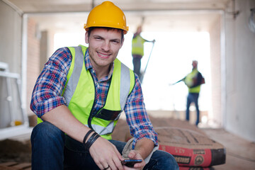 Construction workers using cell phone at construction site