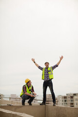 Construction worker and engineer at highrise construction site