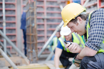 Construction worker with walkie-talkie at construction site