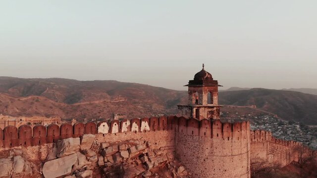 Opposite Amer fort in Jaipur is a watch tower situated, Shot this with the drone at the sunrise. Overlooking the city of Jaipur in India.
