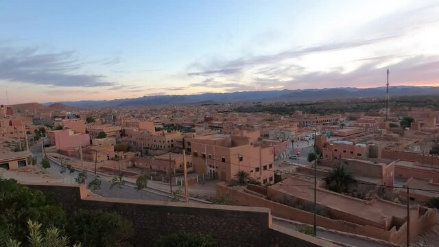 Panorama Of Clay Brick Buildings And Busy Streets In The City Of Tinerhir (Tinghir) In Morocco At Sunset. hyperlapse