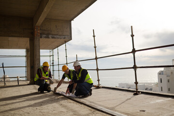 Construction workers working at highrise construction site