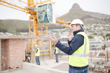 Construction worker with walkie-talkie at construction site