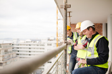 Construction workers talking at highrise construction site