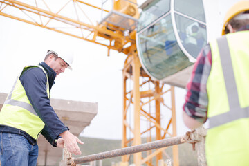 Constructor workers assembling rebar structure at construction site