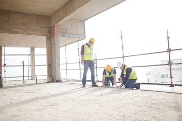 Construction workers working at highrise construction site