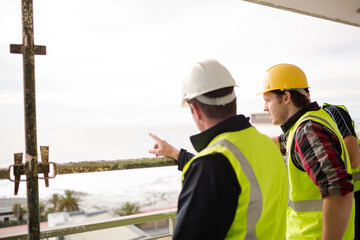 Construction workers talking at highrise construction site