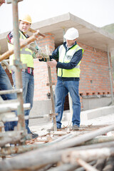 Constructor workers assembling rebar structure at construction site